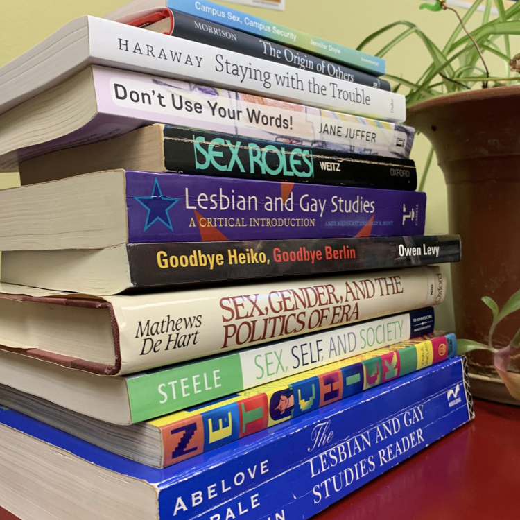 A stack of books relating to LGBT studies.